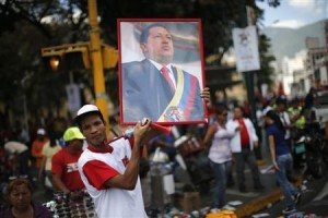 A supporter of Venezuela's President Hugo Chavez holds up a portrait of him while attending a rally in Caracas