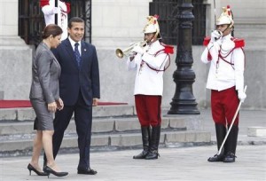 Costa Rica's President Chinchilla talks with Peru's President Humala next to honor guards after a private meeting at the Government Palace in Lima