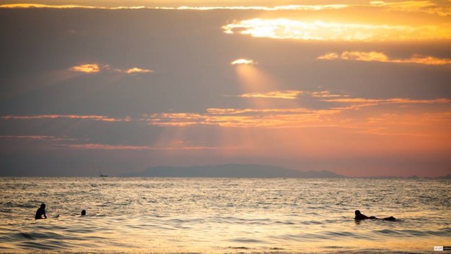 scott alexander surfing at sunset