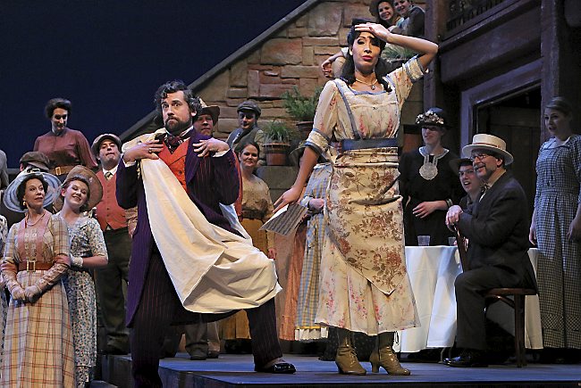 Andrew Wilkowske as Dr. Dulcamara and Nicole Cabell as Adina in the Minnesota Opera production of The Elixir of Love. Music by Gaetano Donizetti Libretto by Felice Romani  After Eugène Scribes text for the opera Le philter by Daniel-François-Esprit Auber (1831) World Premiere at the Teatro Cannobiana, Milan, May 12, 1832 Creative Team Conductor  Leonardo Vordoni Stage Director  Helena Binder Lighting Designer and Scenic Coordinator  Marcus Dilliard Costume Designer  Martin Pakledinaz   The Cast Giannetta  Shannon Prickett Nemorino  Leonardo Capalbo Adina  Nicole Cabell Belcore  David Pershall Dr. Dulcamara  Andrew Wilkowske